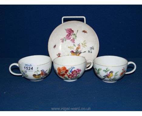 Three Meissen cups and a saucer decorated with buds and flowers.