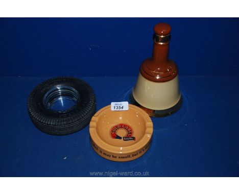 A Bell scotch whisky bell and Gold Label and Firestone Ashtrays.