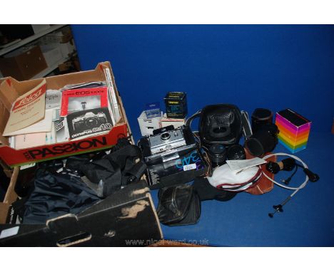 A large quantity of assorted camera equipment to include; lenses, dark room equipment, etc and a Polaroid 335 land camera.