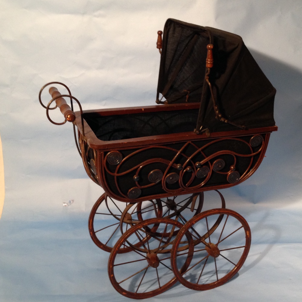 A Vintage German style Baby Doll pram made from wood and wicker with