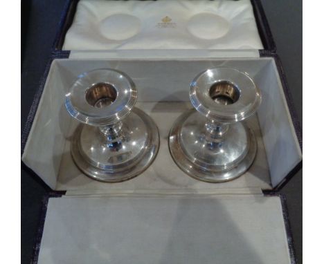 A fine pair of silver desk candlestick by Asprey in case