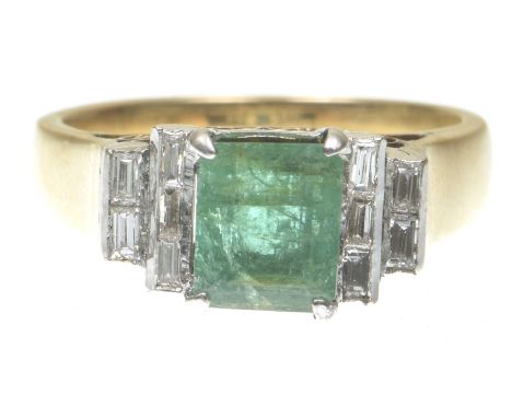 An Art Deco style emerald and diamond ringCentering a step-cut emerald to graduated baguette-cut diamond set step shoulders, 