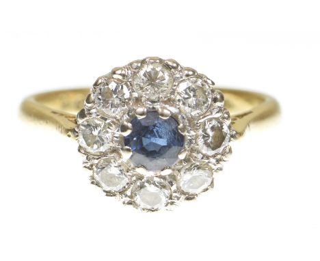 A sapphire and diamond cluster ringCentering a circular shape sapphire within an round brilliant-cut diamond ring, shank 18ct