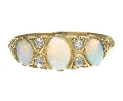 An opal and diamond ringThe graduated oval cabochon opals with old-cut diamond highlights, with a carved scroll gallery, mode