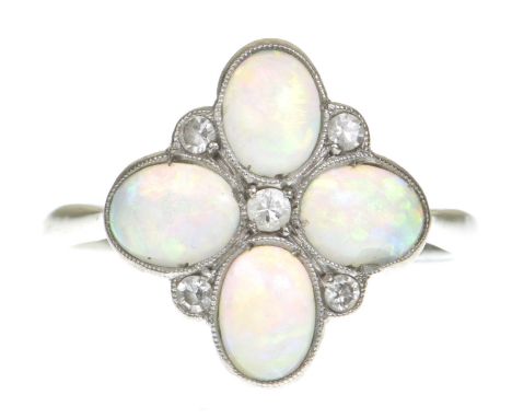 An Edwardian opal and diamond ringThe cabochon opals in a quatrefoil design with single-cut diamond highlights, centering a r