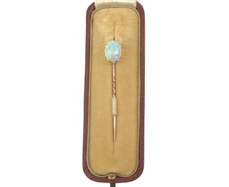 An early 20th century opal stick pinThe oval shape cabochon opal, claw set, to an unmarked precious yellow metal pin, length 