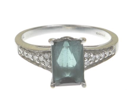 A green tourmaline and diamond ringCentering a step-cut tourmaline to round brilliant-cut diamond shoulders, modelled in prec