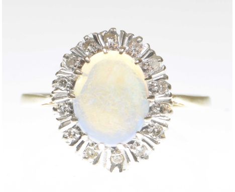 An opal and diamond cluster ringCentering an oval cabochon opal to a single-cut diamond surround, to a precious yellow metal 