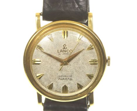 Lanco: An 18k gold manual wind wristwatchThe chased silvered signed dial with applied gilt hour markers, the gold hands with 