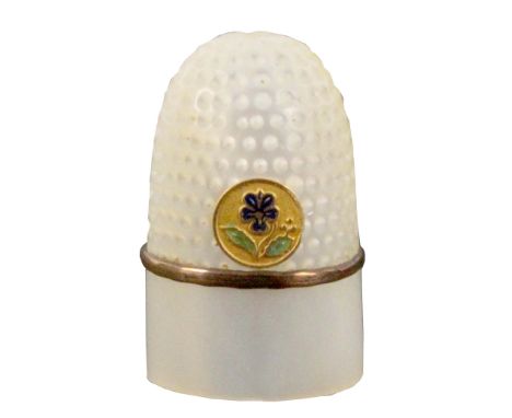A good Palais Royal mother of pearl thimble with inset circular gilt and enamel pansy motif, over a gilt rim over a plain fri