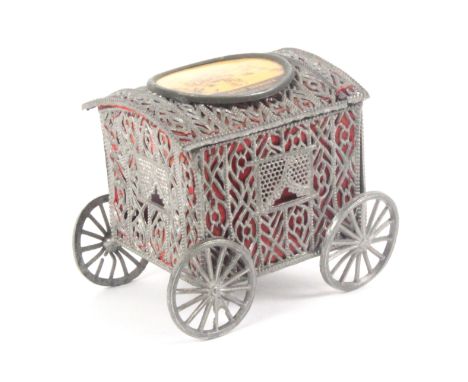 A late Victorian soft metal souvenir model of a bathing cart, the sides with pierced decoration backed by red silk one end wi