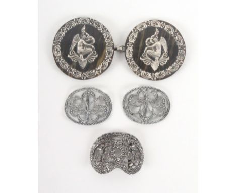 A cloak clasp and three shoe buckles, the clasp of two circular simulated horn panels applied with white metal angels within 