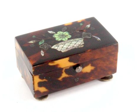 A good early 19th Century tortoiseshell needle packet box, labelled for Fisher, of rectangular form raised on four turned bon