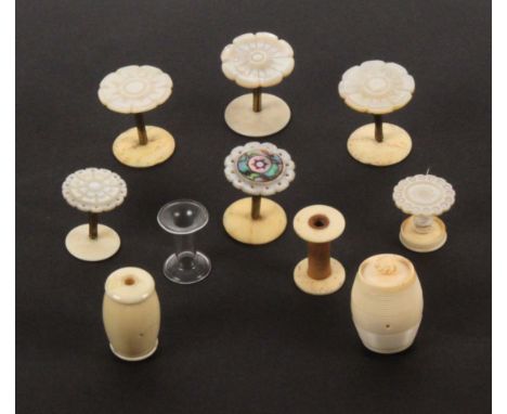 A group of reels, reel holders, cotton barrels, and a reel box, comprising a pair of mother of pearl top reel holders, 3.2cms