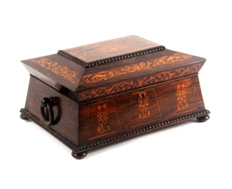 A rosewood and inlaid sewing box, circa 1840, of sarcophagal form, the front and lid inlaid in pale wood with floral and leaf