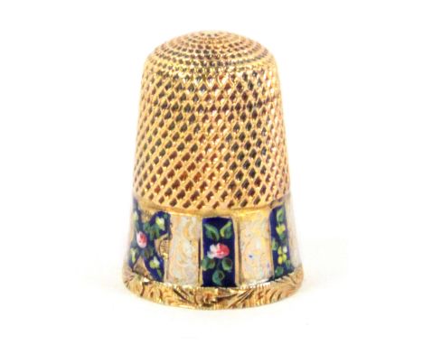 A 19th Century gold thimble, French, the frieze in alternate white and gold enamel and blue floral panels with a central X fo