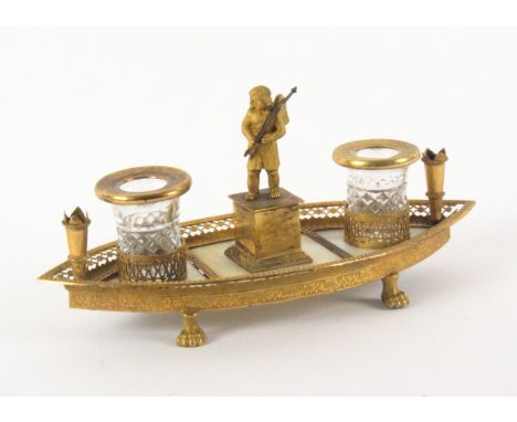 An attractive Palais Royal boat shaped inkstand, in cut glass, gilt metal and mother of pearl, raised on four lion paw feet w