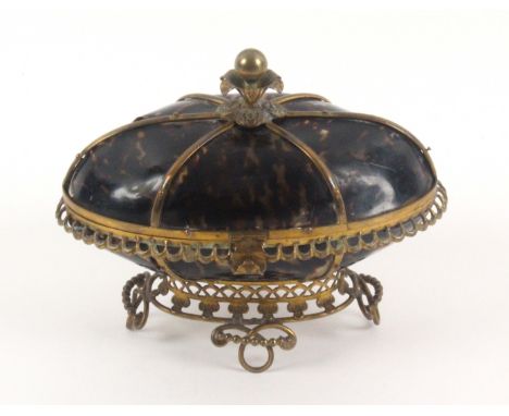 An attractive tortoiseshell and gilt mounted French oval etui, circa 1870, the pierced base raised on four looped feet, the b