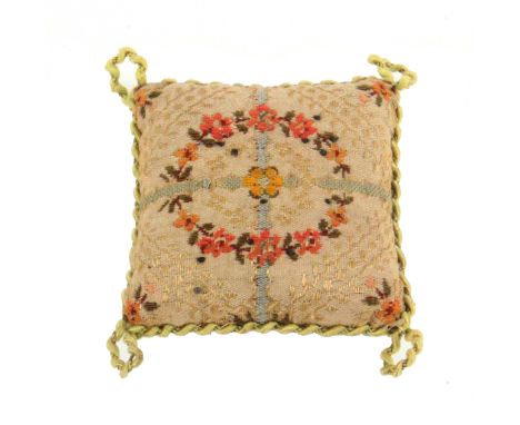 Princess Mary's pin cushion, one side in floral and leaf material within silk rope work border with corner circles, 11cms sq.