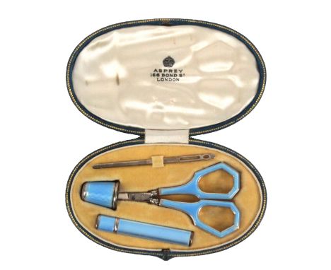 A blue leather cased four piece white metal and enamel sewing set 'Asprey, 166 Bond St., London', the gilt tooled oval case i