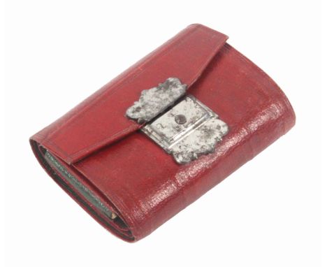 A Georgian red leather hussif, with polished steel catch, the interior in green leather and fitted as a skein holder with an 