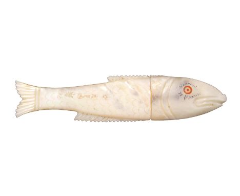 An unusual French mother of pearl needle case, carved in the form of a fish with engraved scales and inscribed around one eye