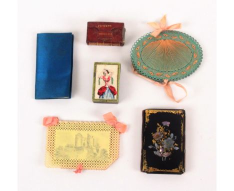 Four needle books and two needle packet boxes, comprising a floral decorated papier mache needle book with bone stylus closur