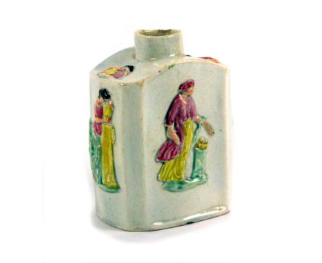 A Staffordshire pearlware tea caddy, late 18th Century, of silver shape, moulded in relief with figures, 10cms high.         