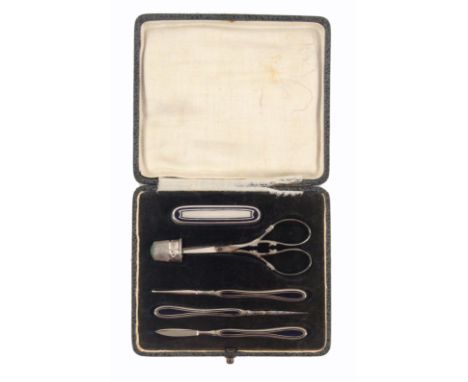 A six piece German white metal sewing set, contained in a leatherette rectangular case, the flush fitted base with steel scis