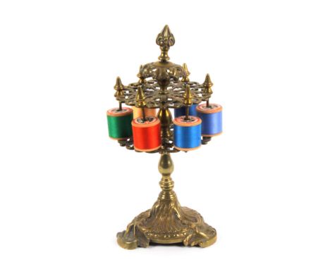 An elaborate mid 19th Century cast brass reel stand, the leaf scroll base to a baluster pedestal supporting two pierced circu