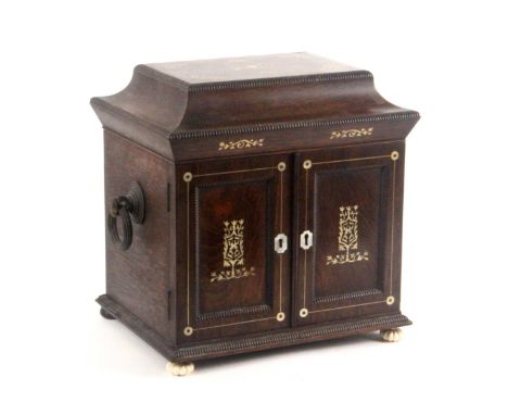 A rosewood and mother of pearl inlaid sewing/jewellery and writing cabinet, circa 1840, the front enclosed by a pair of doors