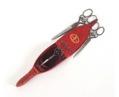 A cased set of three pairs of graduated steel scissors, the red leather gilt tooled case with oval gilt stamp 'Wingfield, Row