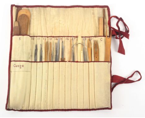 A comprehensive set of 19th Century netting tools, contained in a glazed cotton and red silk ribbon border roll form case. Th