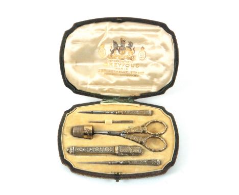 An attractive early 20th Century leather cased etui by Dreyfous, Paris, the shaped rectangular case faded to brown with elabo