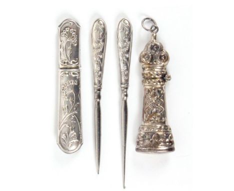 Two silver needle cases and two related tools, comprising a curved end rectangular needle case decorated with flowers and lea