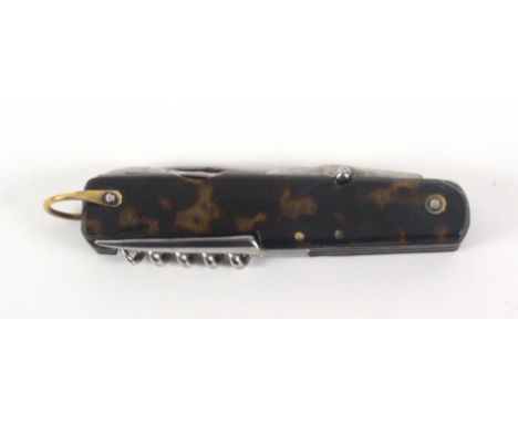 An early 20th Century French pocket knife, with simulated tortoiseshell scales, with eight folding tools and blades, one stam