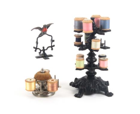 Three 19th Century reel stands, comprising a leaf decorated cast iron and wooden example of three tiers, finial replaced, 21c