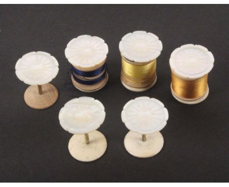 A set of six mother of pearl flower top reel holders, with brass stems and bone bases, one with replacement wooden base, 3.2c