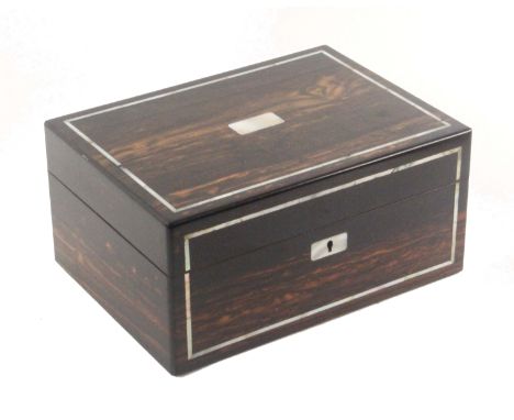 A mid Victorian coromandel wood rectangular sewing box, the top and front inlaid with bands of mother of pearl, the lid later