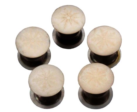 A fine set of five reels, circa 1870, each with domed mother of pearl ends elaborately engraved with leaves within trellis bo