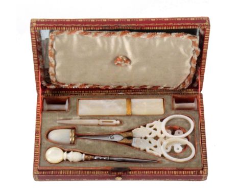 A late 18th Century French Palais Royal sewing set contained in a rectangular red leather case with gilt tooled decoration, t