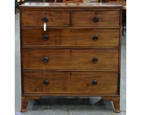 A VICTORIAN MAHOGANY CHEST OF DRAWERS, C1870, WITH EBONY KNOBS, ON SPLAYED FEET, 109CM H; 49 X 108CM Old blackened, somewhat 