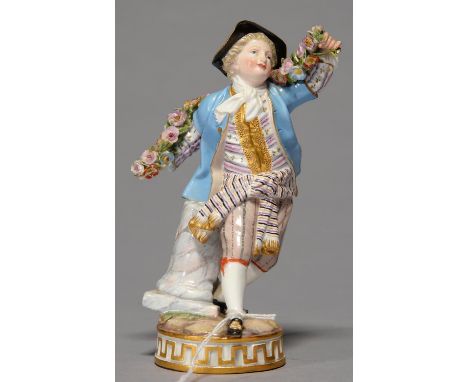 A MEISSEN FIGURE OF A YOUTH WITH A GARLAND, LATE 19TH C, IN BLACK HAT AND LIGHT BLUE COAT, WITH GILT WAISTCOAT AND STRIPED BR