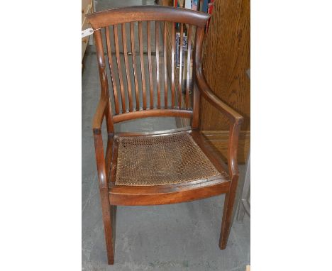 AN EDWARDIAN MAHOGANY STICK BACK ELBOW CHAIR WITH DISHED, CANED SEAT, C1910 Typical wear consistent only with age