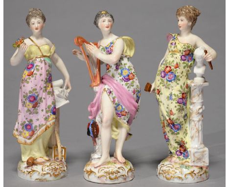 A SET OF THREE GERMAN PORCELAIN FIGURES OF MUSIC, GEOMETRY AND ART, LATE 19TH C, AS CLASSICAL MAIDENS BEARING DIFFERENT ATTRI