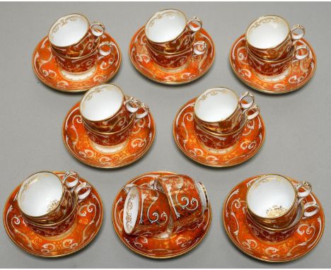 A FINE DAVENPORT TEA AND COFFEE SERVIC, C1855, OF EIGHT RING HANDLED TRIOS, RICHLY GILT WITH FOLIATE SCROLLS ON A WIDE ORANGE