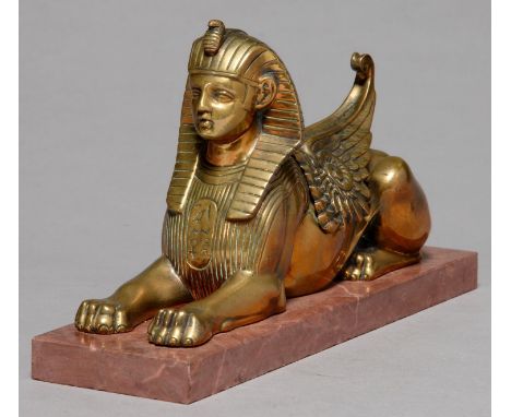 EGYPTOMANIA.&nbsp; A BRONZE SCULPTURE OF THE SPHINX, C1870, ON ASSOICATED MARBLE BASE, 17.5CM L Old polish residues, wings (c