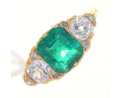 AN EMERALD AND DIAMOND THREE STONE RING,&nbsp; THE STEP CUT EMERALD FLANKED BY CUSHION SHAPED OLD CUT DIAMONDS AND DIAMOND AC