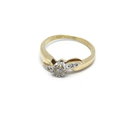 An 18carat gold ring set with a brilliant cut diamond flanked by smaller diamonds with a twist shaped shank. Ring size K.