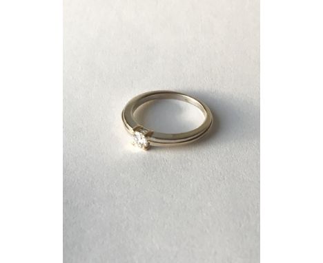 An 18carat white and yellow gold modern design ring set with a solitaire diamond approximately 0.25 of a carat ring size L-M